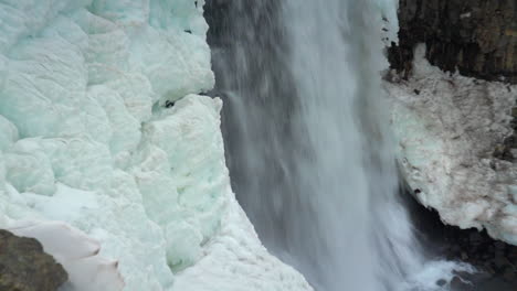 Water-Cascading-Through-Icy-Basalt-Column-Cliff