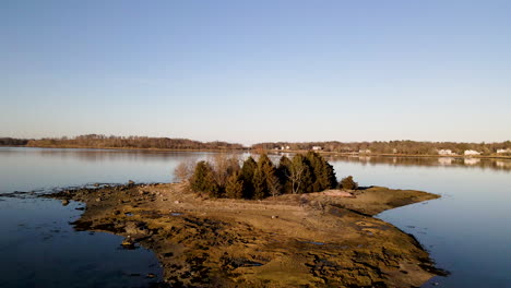 Aerial-Drone-footage-of-a-Deserted-Island-set-in-a-peaceful-harbor-lake-setting