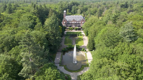 Jib-up-of-beautiful-mansion-with-a-spewing-water-fountain-in-the-foreground