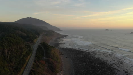 Aerial-View-Of-Oregon-Coast-Highway-Passing-Through-Humbug-Mountain-State-Park-On-A-Sunset