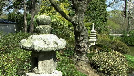 Camera-jibs-down-bringing-Japanese-stone-lantern-into-view