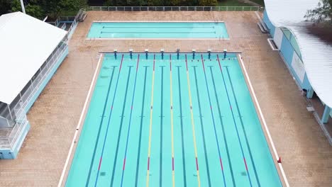 santo-domingo,-dominican-republic---23-july-2021---aerial-view-of-swimming-court-without-people-carefully-clean,-swimming-sport-location,-aquatic-classes-in-pool