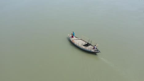 Drone-shot-of-Indian-couple-on-moving-boat-in-river,-romantic-date