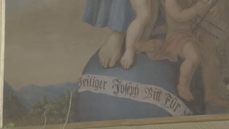 Close-up-of-a-painting-with-a-banner-"Saint-Joseph-Supplicate-for-Us