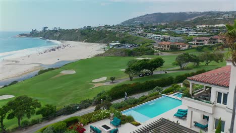 Aerial-view-of-Monarch-beach-golf-course-and-the-beach-over-a-swimming-pool-and-walking-trail