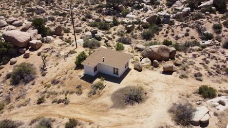 Orbiting-small-desert-house-surrounded-by-boulders-in-middle-of-nowhere