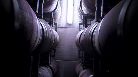 Drone-Descend-Between-Stack-Of-Traditional-Oak-Wine-Barrels-In-A-Rack-House
