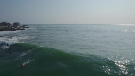 Drone-shot-of-a-surfer-riding-a-wave-in-to-shore