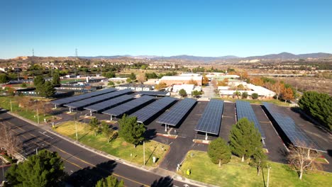 Solar-panels-provide-shade-in-a-parking-lot-as-well-as-clean-renewable-energy---aerial-flyover