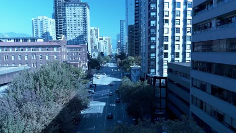 St-Pauls-hospital-downtown-Vancouver-Burrard-4k-aerial-drone-flyover-quiet-sunny-streets-fall-spring-overlooking-light-traffic-Davie-to-See-em-ia-Laneway-with-mountains-surrounding-city-skyscrapers