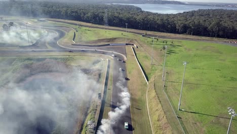 Racing-Cars-Speeding-On-The-Race-Track-In-Sydney-Motorsport-Park,-Australia---aerial-shot