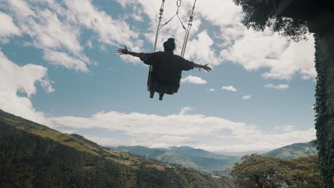 Tourist-On-Swing-At-The-End-of-the-World-In-Casa-del-Arbol,-Banos-Ecuador
