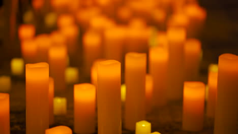 Many-candles-lit-in-a-dark-room-during-a-event