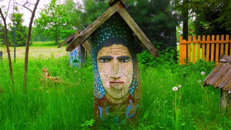 Vintage-Colorful-Wooden-Sculptures-At-The-Yards-Of-Chata-Kaszubska-Regional-Museum-In-Poland