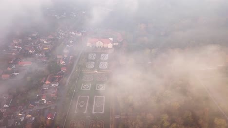 Foggy-aerial-view-of-Castle-and-beautiful-majestic-gardens