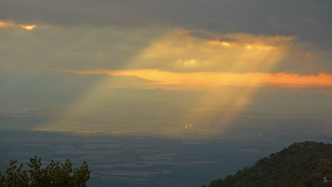 Light-rays-shining-through-clouds-in-Catalan-mountain-range,-Spain