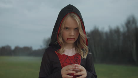 Close-Up-Medium-Video-of-Girl-in-Halloween-Dracula-Costume-Pulling-Faces-and-Grimaces