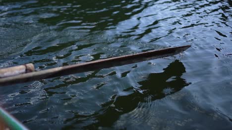 Close-up-shot-of-wooden-Oar-in-the-river-paddling-in-Slow-motion