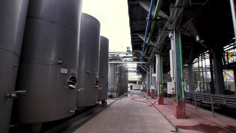 Many-rows-of-medium-sized-steel-tanks-for-wine-at-a-winery