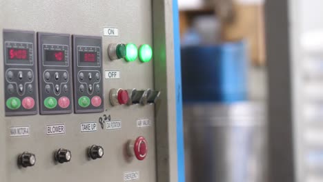 Industrial-Machine-Control-Panel-At-Plastics-Factory-With-Bokeh-Background