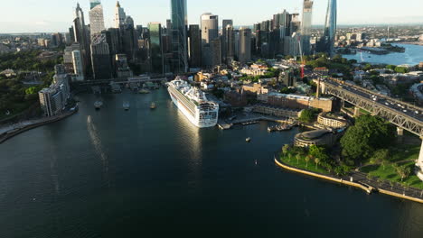 Cruise-Ship-At-Overseas-Passenger-Terminal-With-Sydney-Skyline-In-Australia