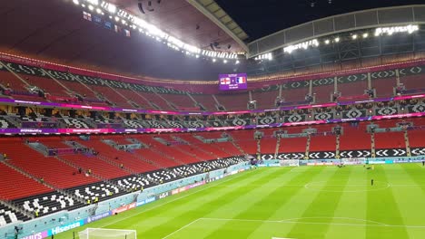Empty-stadium-prepare-to-host-England-France-football-national-team-and-the-flag-waving-in-the-score-board-screen-monitor-in-stadium-al-Bayt-modern-well-designed-architecture-inspired-by-nomad-tent