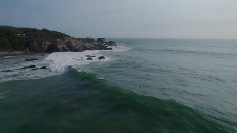 Aerial-shot-of-surfers-waiting-for-the-perfect-wave-in-Mexico