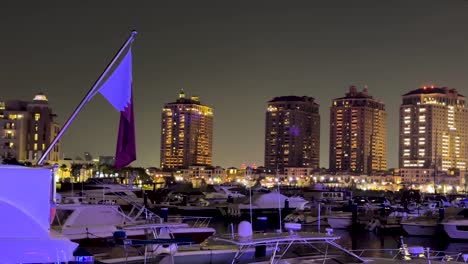 Qatar-flag-on-an-expensive-big-Yacht-in-lagoon-pearl-Venice-like-Qanat-Quartier-in-Doha-at-night