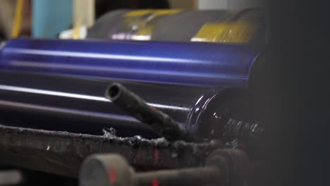 Close-Up-Of-Metal-Rollers-In-Factory-Turning