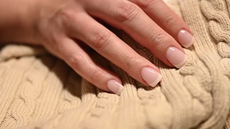 slow-slider-over-perfect-French-manicured-fingernails-over-a-beautiful-sweater