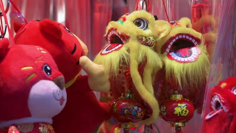 Chinese-New-Year-decorative-ornaments,-such-as-yellow-lions,-seen-for-sale-at-a-shop-ahead-of-the-Lunar-Chinese-New-Year-in-Hong-Kong