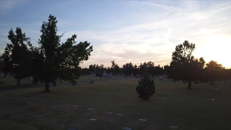 Backward-dolly-above-a-cemetery-in-Georgia-during-sunset