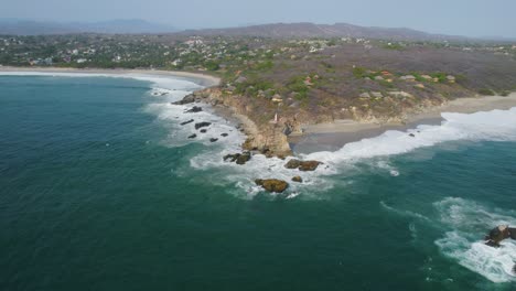 Wide-aerial-view-of-the-coast-at-Punta-Zicatela,-Mexico