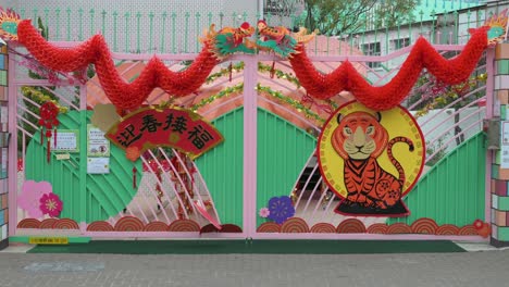 Eine-Familie-Geht-An-Einem-Kindergarten-Vorbei,-Der-Vor-Dem-Bevorstehenden-Chinesischen-Neujahrsfest-In-Hongkong-Mit-Chinesischen-Neujahrsornamenten-Geschmückt-Ist