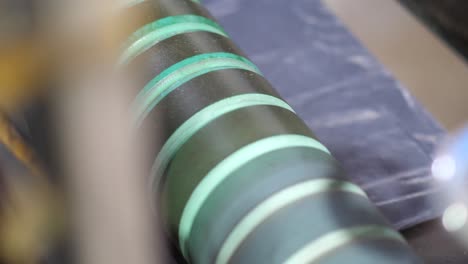 Close-Up-View-Of-Plastic-Cellophane-Bags-Going-Under-Rollers-At-Factory-And-Being-Cut-To-Size