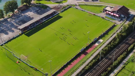 Static-aerial-shot-of-football-game-in-city-Kuchl