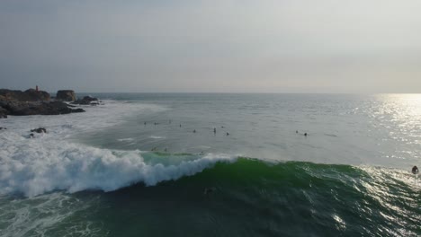 Aerial-shot-of-a-surfer-catching-a-wave-in-Mexico