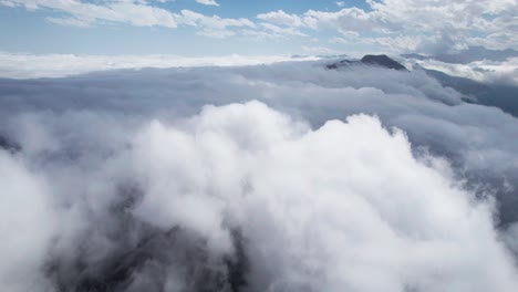 Aerial-shot-of-Thermessos-peaking-above-the-clouds-in-Antalya,-Turkey