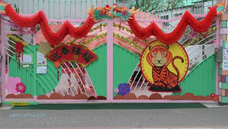 Pedestrians-walk-past-a-kindergarten-school-decorated-with-Chinese-New-Year-ornaments-ahead-of-the-upcoming-Lunar-Chinese-New-Year-in-Hong-Kong