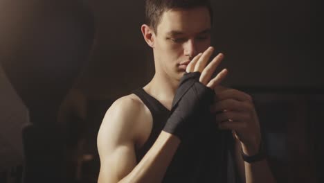 Caucasian-Boxer-Wrapping-Hand-With-Black-Bandage