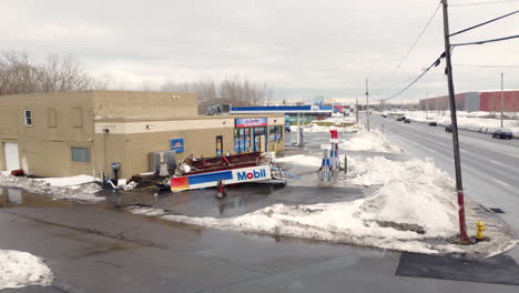 Aerial-view-up-dismissed-petrol-station-with-roof-destroyed