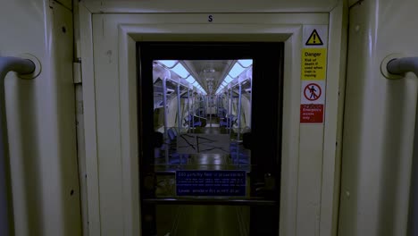 Looking-Through-Door-Connecting-To-Another-Empty-Train-Carriage-On-The-Jubilee-Line-Train-In-London