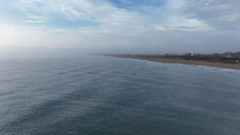 Scenic-aerial-drone-view-of-shore-of-Costa-Brava,-flying-forward-on-foggy-day