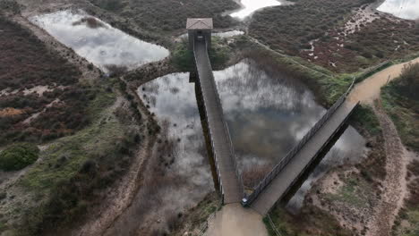 Estartit-nature-reserve-wooden-bridges-and-bird-watching-platform-boardwalk-over-marsh-pools-aerial-view