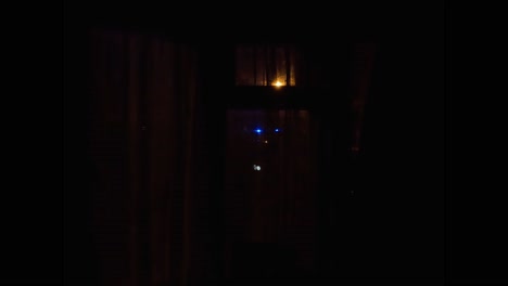Flashing-Blue-Emergency-Lights-Seen-Through-Curtains-At-Night