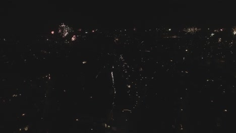 Backing-drone-shot-of-skyline-with-new-years-fireworks