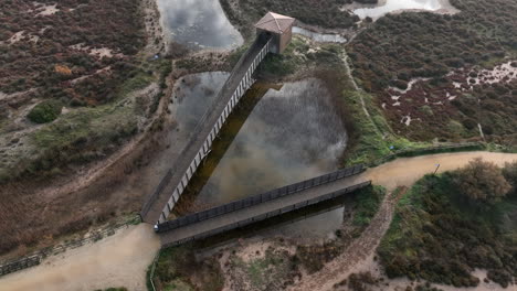 Establisher-aerial-of-wooden-bridges-walk-path-in-Costa-Brava,-Spain,-circle-pan