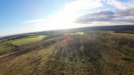 FPV-drone-flying-across-Billinge-hill-beacon-stone-circle-on-autumn-Lancashire-farmland