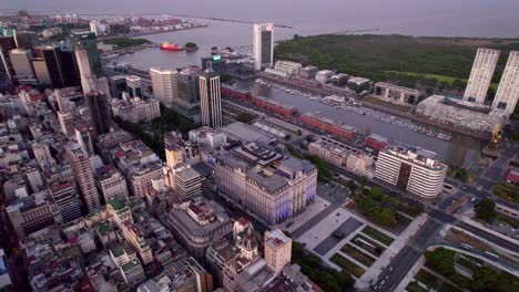 Aerial-view-dolly-in-of-the-old-and-representative-architecture-of-the-city-of-Buenos-Aires,-with-the-entrance-to-the-port,-Puerto-Madero,-tourist-place-of-the-city