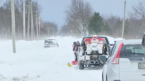 Car-get-stuck-during-a-winter-snow-blizzard-In-Canada,-towing-truck-on-standby-for-help